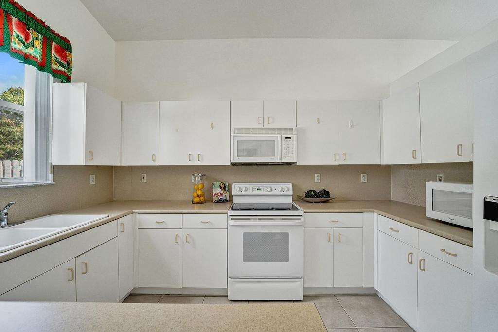 13175 Southwest 24th Street Miramar, FL 33027 - Photo 15 of 66 Spacious kitchen with white appliances.