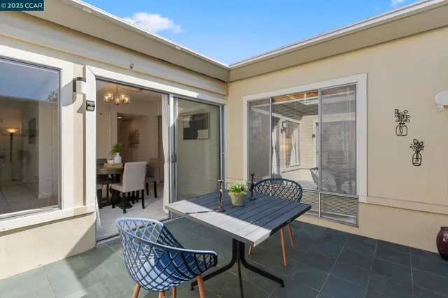a outdoor dining space with furniture and outdoor view