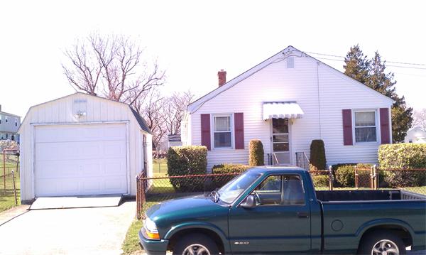 83 Lepes Road Tiverton, RI 02878 - Photo 4 of 5 a front view of a house with parking space