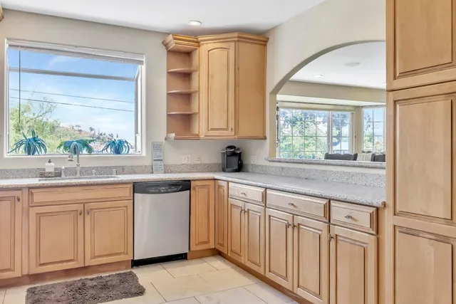 a kitchen with stainless steel appliances white cabinets and a stove top oven