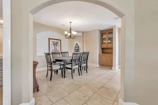 a dining room with furniture and chandelier