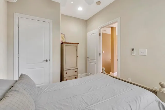 a view of an empty room with wooden floor and windows