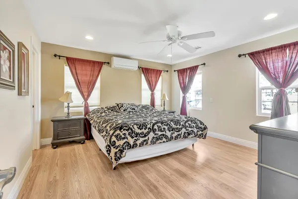 a bedroom with furniture and a large window