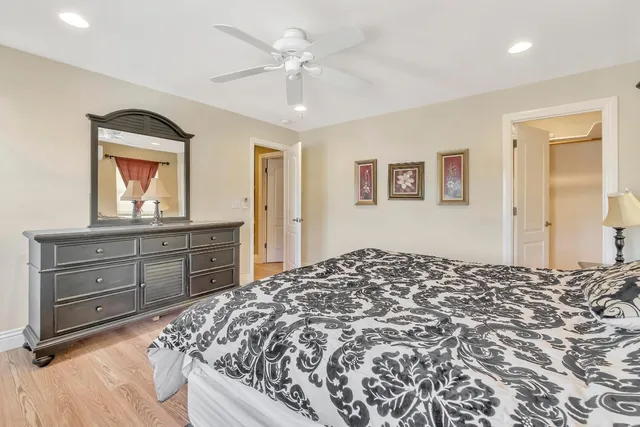 a bedroom with furniture and a large window