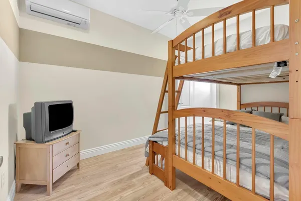 a bedroom with a large bed and a chandelier