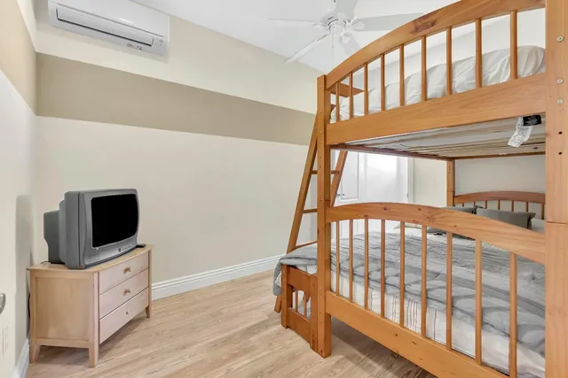 a bedroom with a bed couch and window