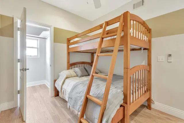 a bedroom with a large bed and a chandelier