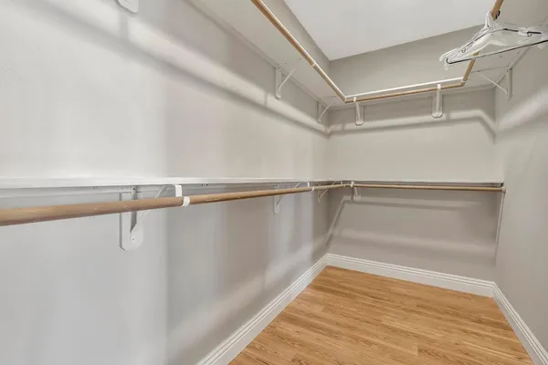 a bathroom with a granite countertop sink a mirror and a shower