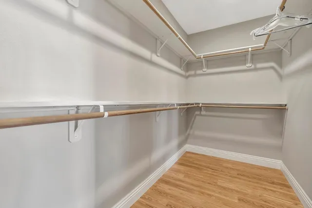 a spacious bathroom with a granite countertop sink mirror and shower