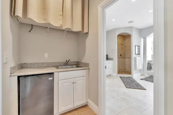 a bathroom with a double vanity sink a mirror and a bathtub