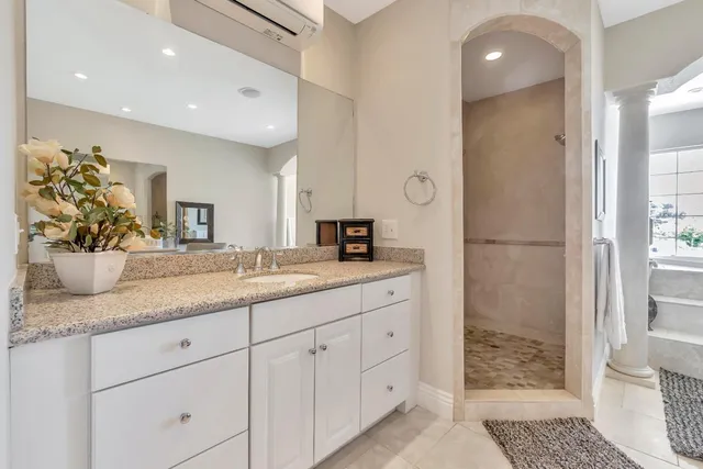 a spacious bathroom with a granite countertop sink and a mirror