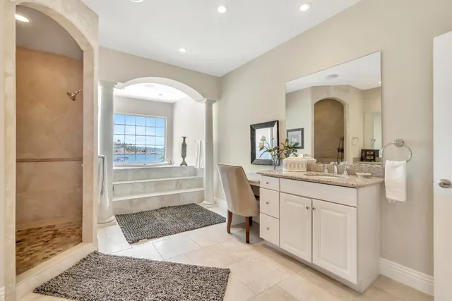 a bathroom with a sink a toilet and a mirror