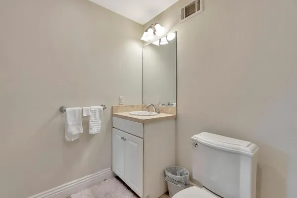 a view of a patio with a dining table and chairs with wooden floor
