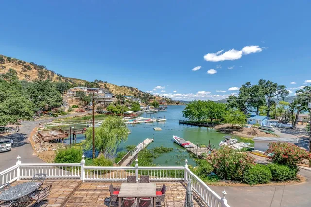 a view of a house with pool and sitting area