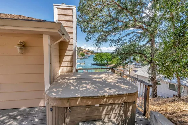 a view of a roof deck with wooden floor and fence