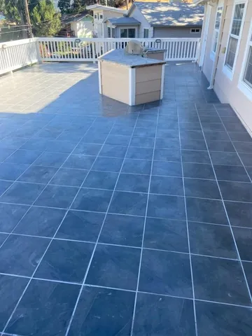 a view of a wooden deck and a garden