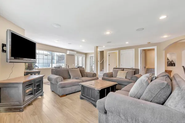 a white kitchen with stainless steel appliances granite countertop a refrigerator sink and microwave