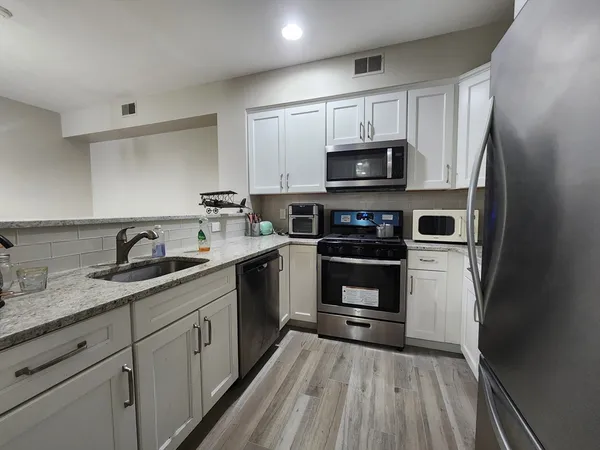 a kitchen with a refrigerator stove and microwave