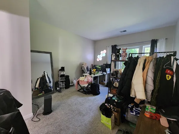 a bedroom with bed and a window