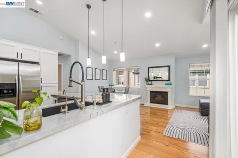 a bathroom with a granite countertop sink mirror vanity and toilet