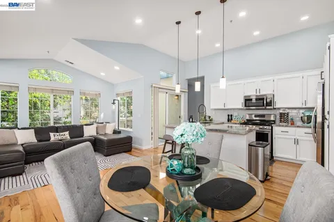 a dining room with furniture a painting and wooden floor