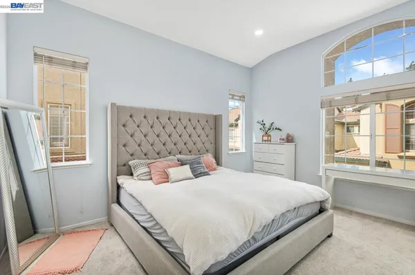 a bedroom with a large bed and a window