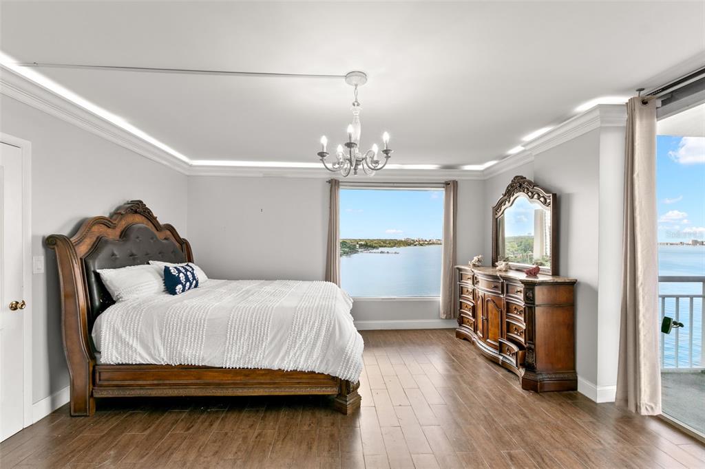 100 Pierce Street, Unit 1007 Clearwater, FL 33756 - Photo 19 of 40 a bedroom with a bed and wooden floor