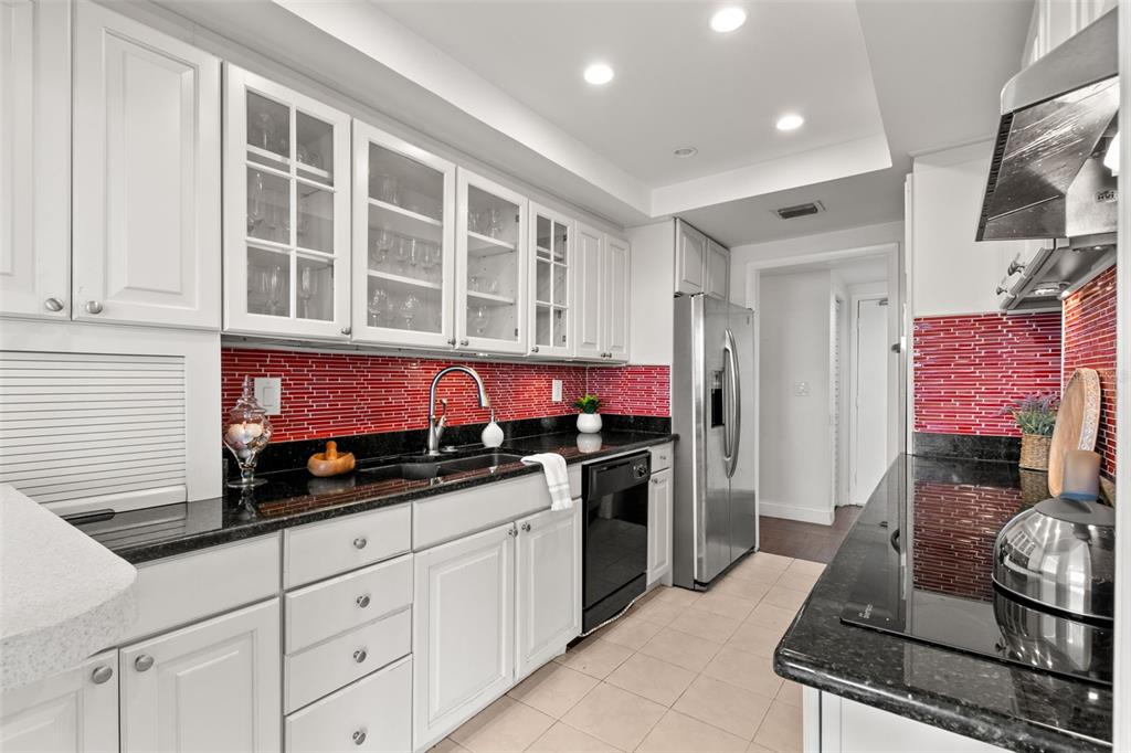 100 Pierce Street, Unit 1007 Clearwater, FL 33756 - Photo 9 of 40 a kitchen with a stove and a refrigerator