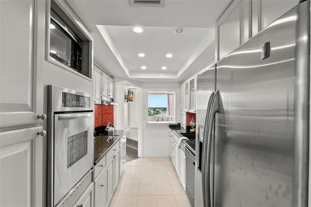 a kitchen with stainless steel appliances a refrigerator and a stove top oven