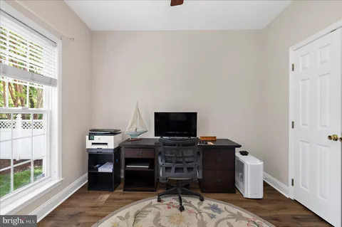 a living room with furniture a window and a flat screen tv