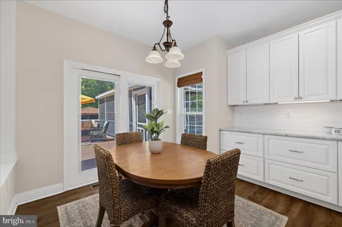 a kitchen with granite countertop stainless steel appliances a stove a sink and a window