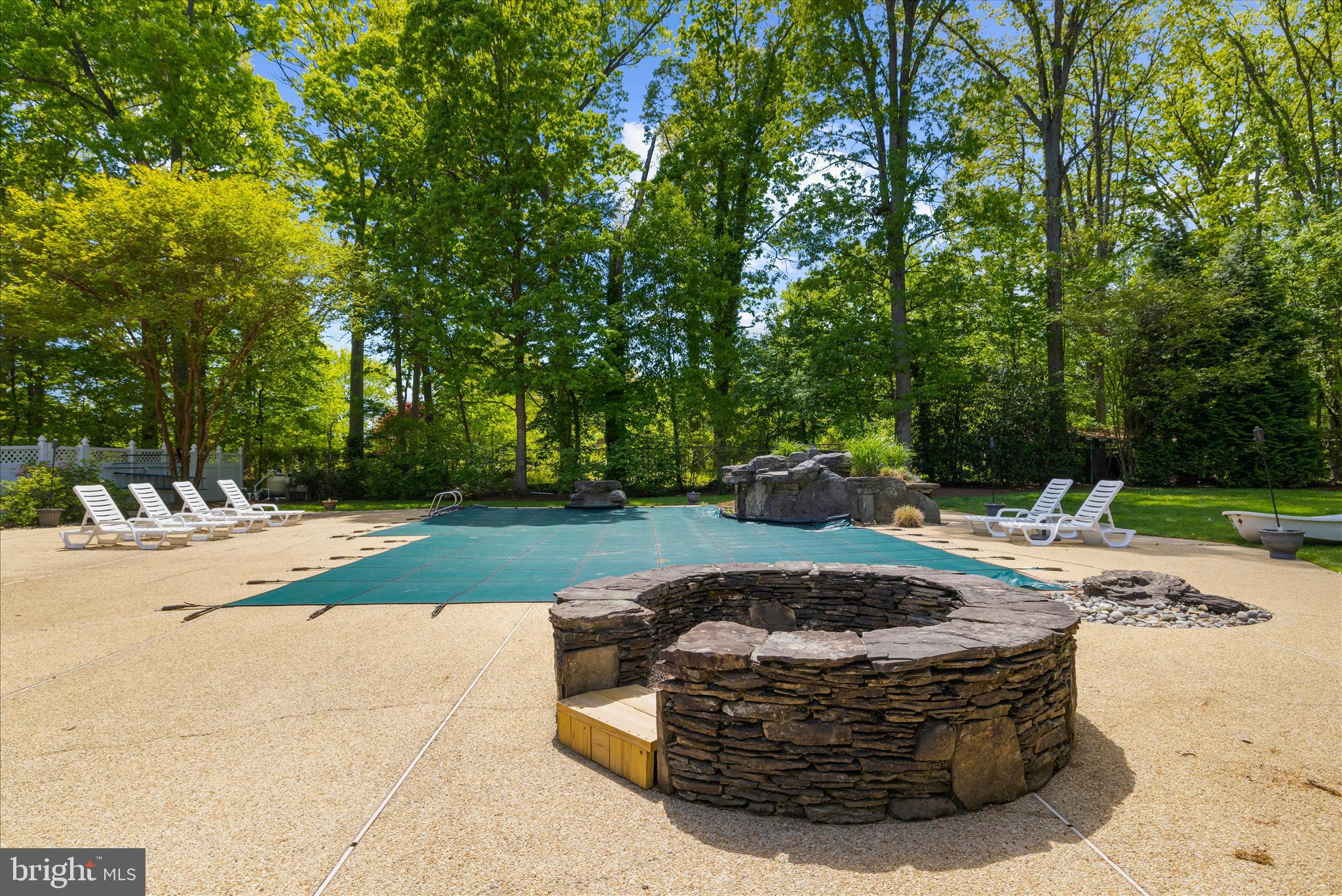 470 Jumpers Hole Road Severna Park, MD 21146 - Photo 56 of 72 a view of swimming pool with a fire pit and trees