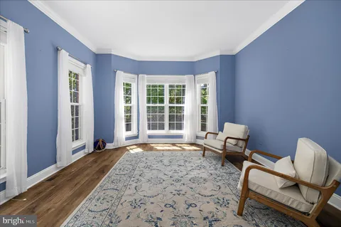 a living room with furniture and a chair