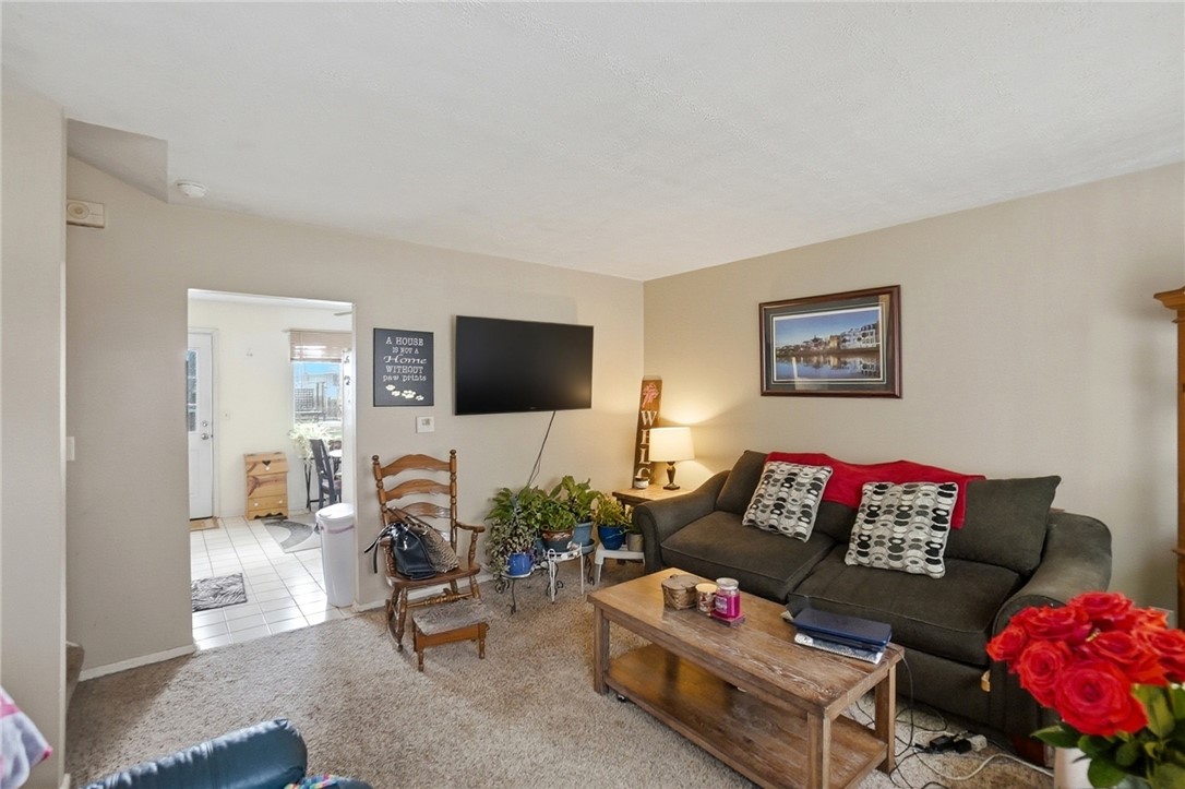 4780 Old Salem Road Englewood, OH 45322 - Photo 6 of 30 This inviting living room offers comfortable carpet flooring and ample space for relaxation.