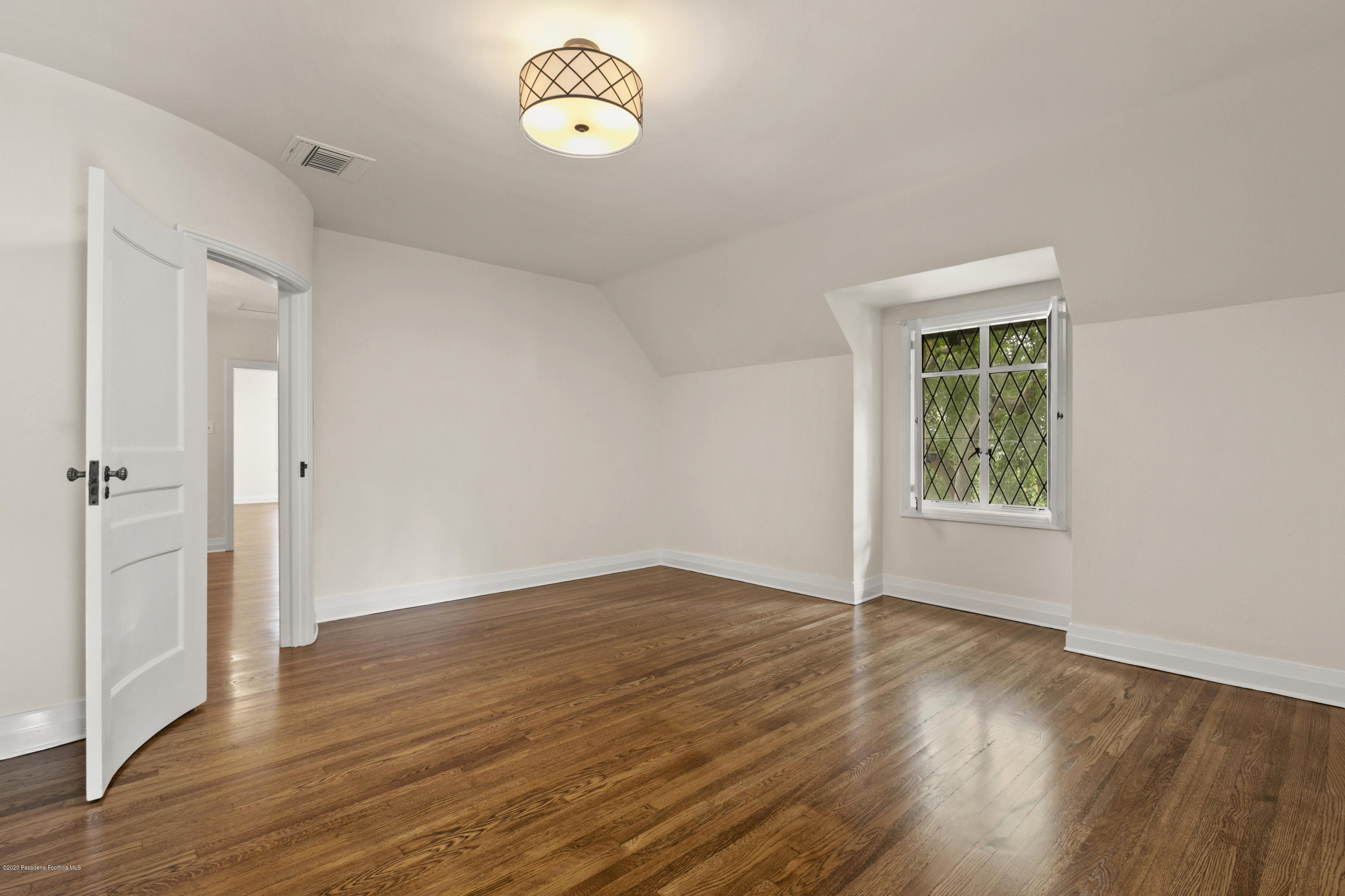 1701 East Altadena Drive Altadena, CA 91001 - Photo 25 of 36 an empty room with wooden floor and windows