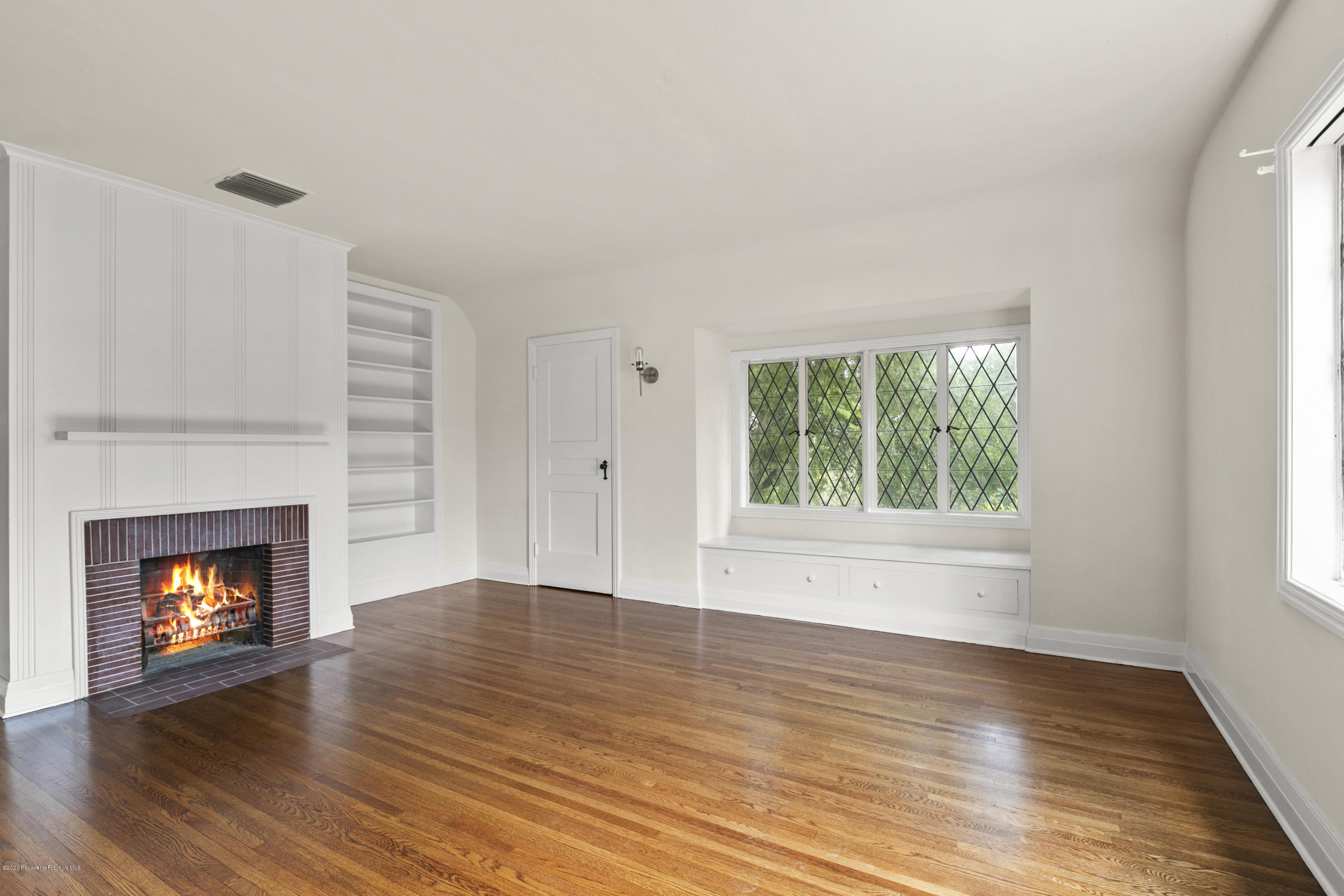 1701 East Altadena Drive Altadena, CA 91001 - Photo 28 of 36 a view of an empty room with wooden floor fireplace and a window