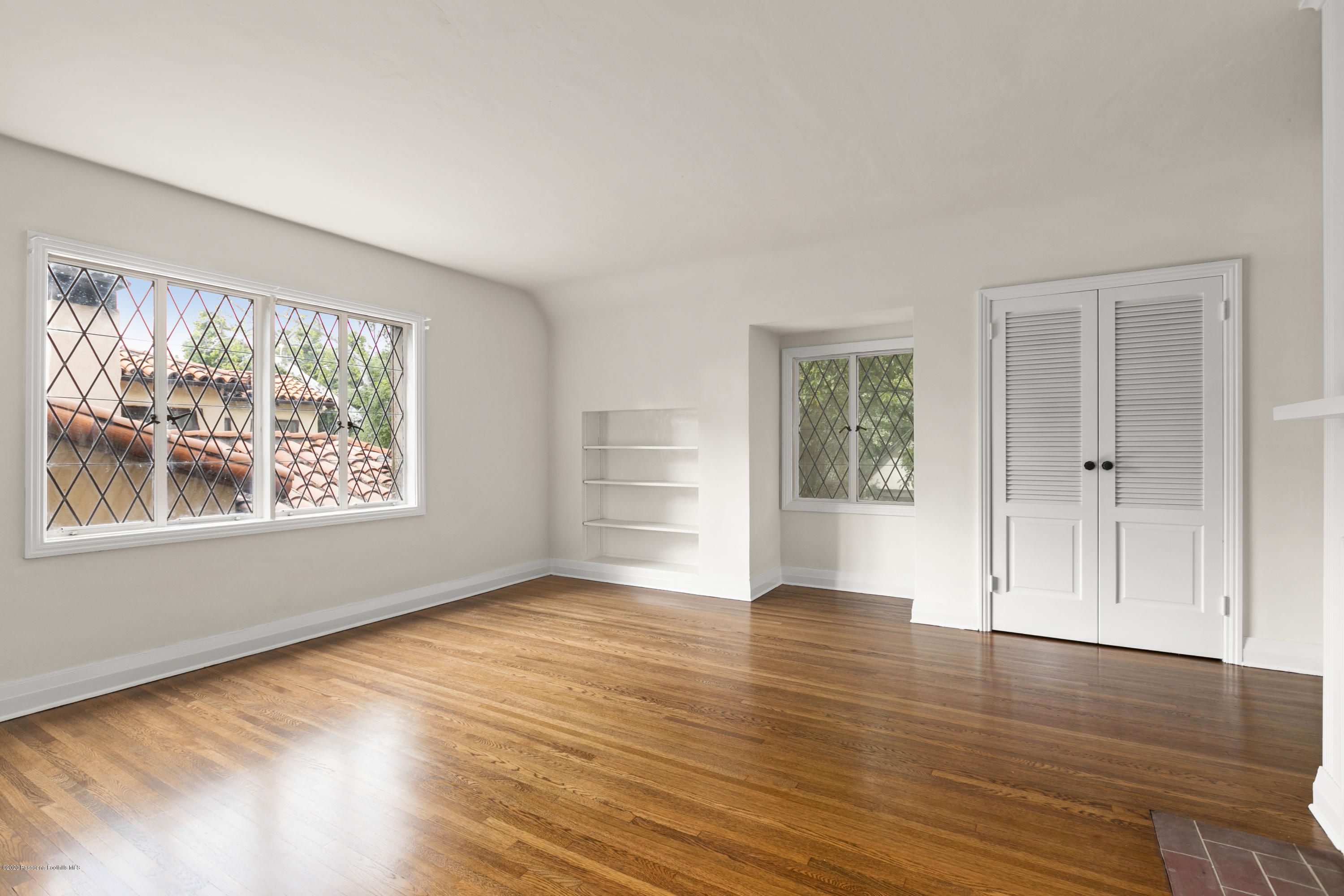1701 East Altadena Drive Altadena, CA 91001 - Photo 30 of 36 a view of an empty room with wooden floor and a window