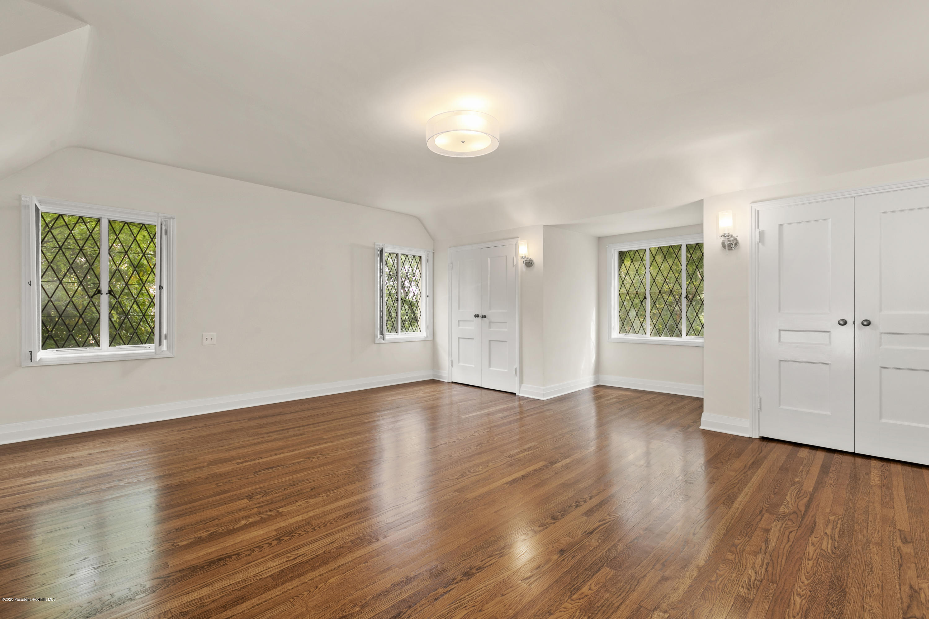 1701 East Altadena Drive Altadena, CA 91001 - Photo 35 of 36 an empty room with wooden floor and windows