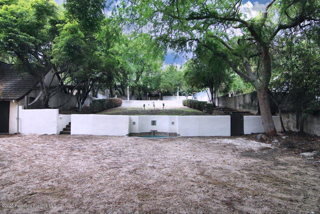 1701 East Altadena Drive Altadena, CA 91001 - Photo 36 of 36 a view of a white house with a yard and large trees