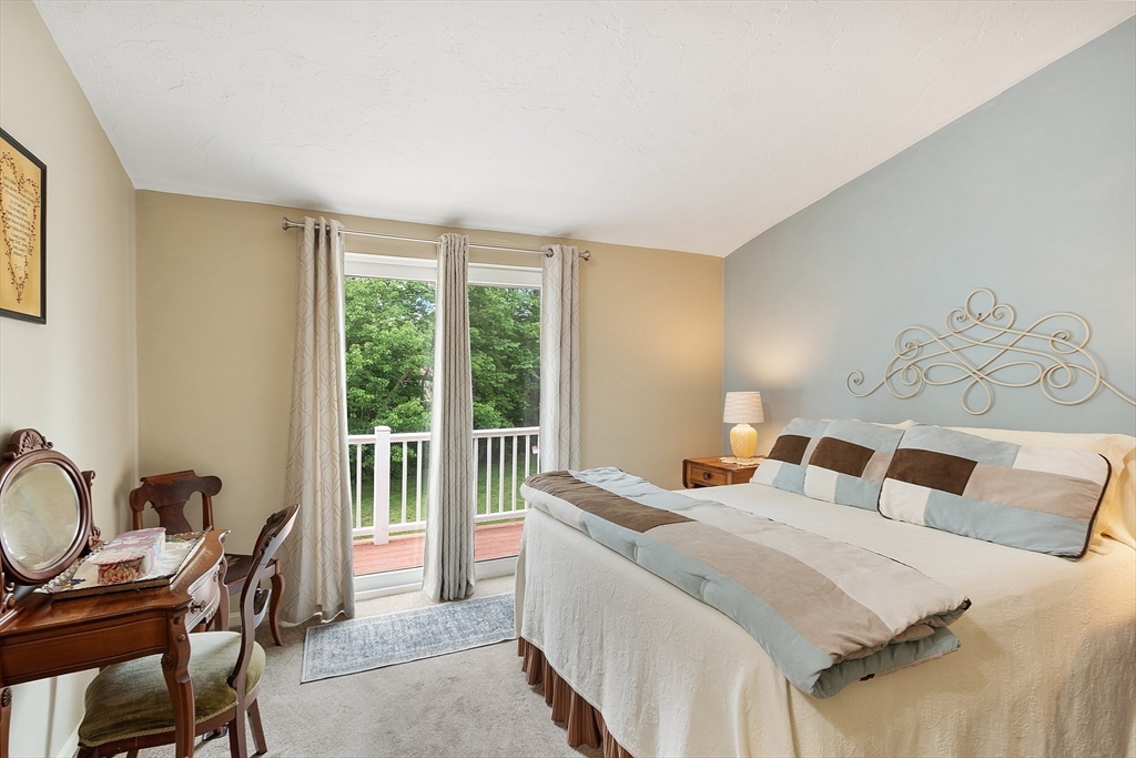 425 Main Street, Unit 8B Hudson, MA 01749 - Photo 14 of 31 a bedroom with a bed and a desk