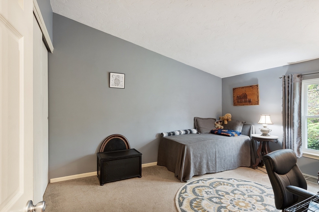 425 Main Street, Unit 8B Hudson, MA 01749 - Photo 20 of 31 a bedroom with furniture and wooden floor