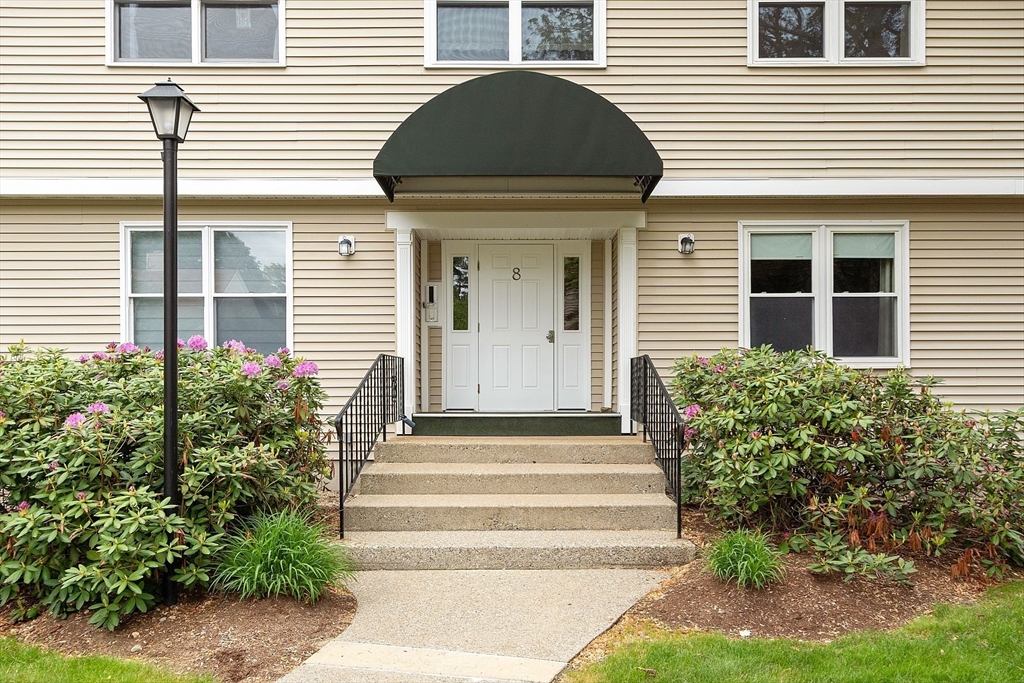 425 Main Street, Unit 8B Hudson, MA 01749 - Photo 2 of 31 a front view of a house with potted plants