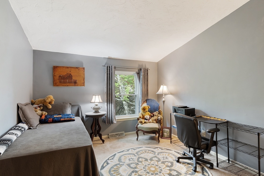 425 Main Street, Unit 8B Hudson, MA 01749 - Photo 21 of 31 a living room with furniture rug and window