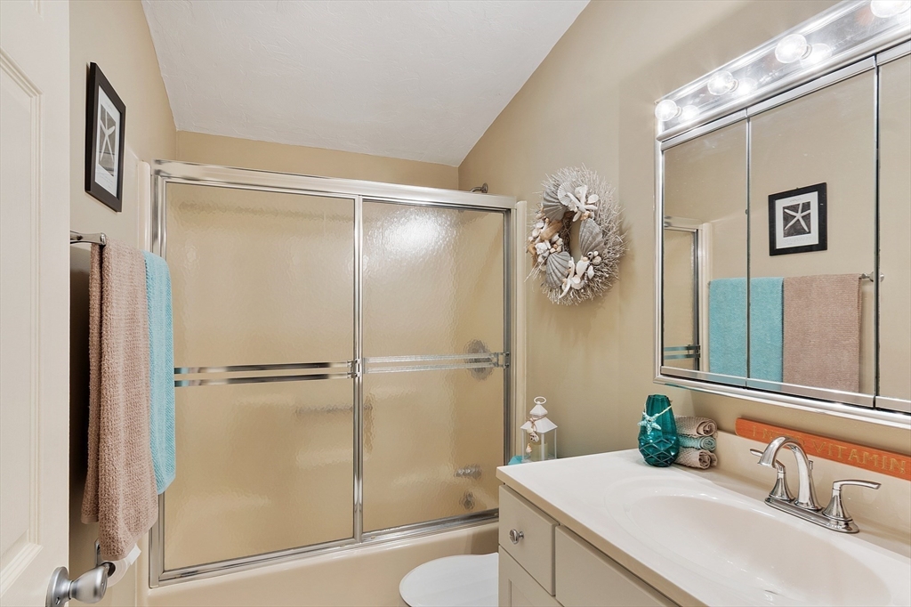 425 Main Street, Unit 8B Hudson, MA 01749 - Photo 23 of 31 a bathroom with a granite countertop sink toilet and shower