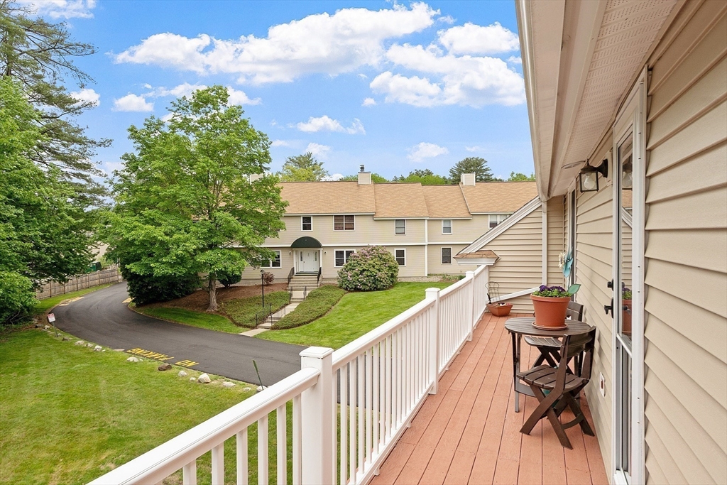 425 Main Street, Unit 8B Hudson, MA 01749 - Photo 25 of 31 a balcony view with two chairs and a table