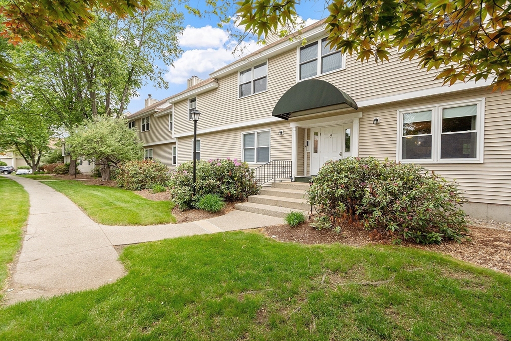425 Main Street, Unit 8B Hudson, MA 01749 - Photo 3 of 31 a front view of a house with a yard