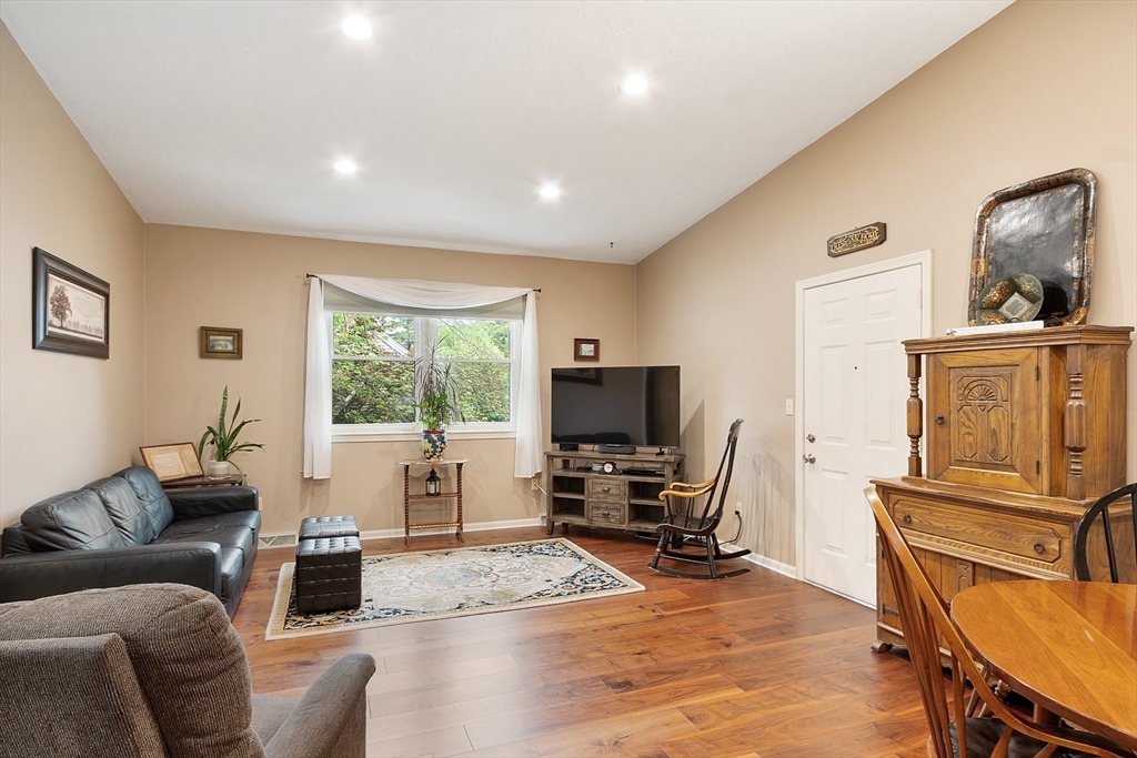 425 Main Street, Unit 8B Hudson, MA 01749 - Photo 6 of 31 a living room with furniture a window and a flat screen tv
