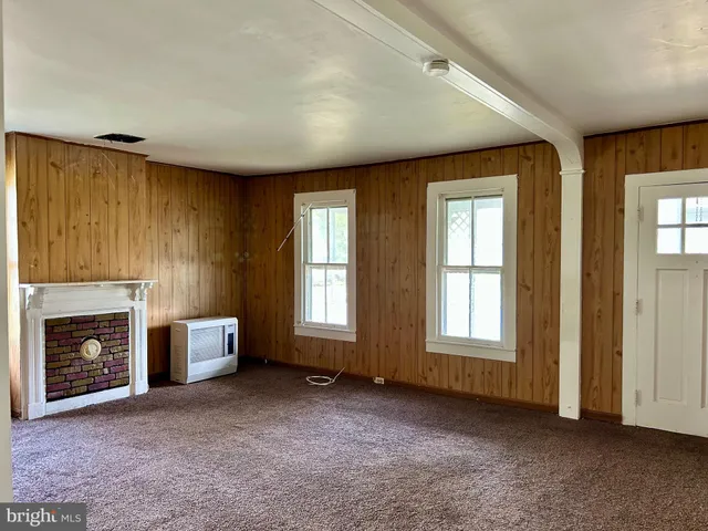 an empty room with furniture and a fireplace