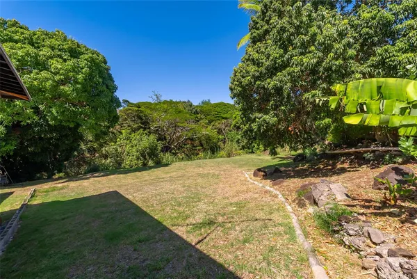 a view of a house with pool and a yard