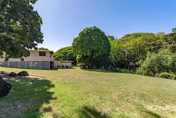 a view of a house with a yard and swimming pool